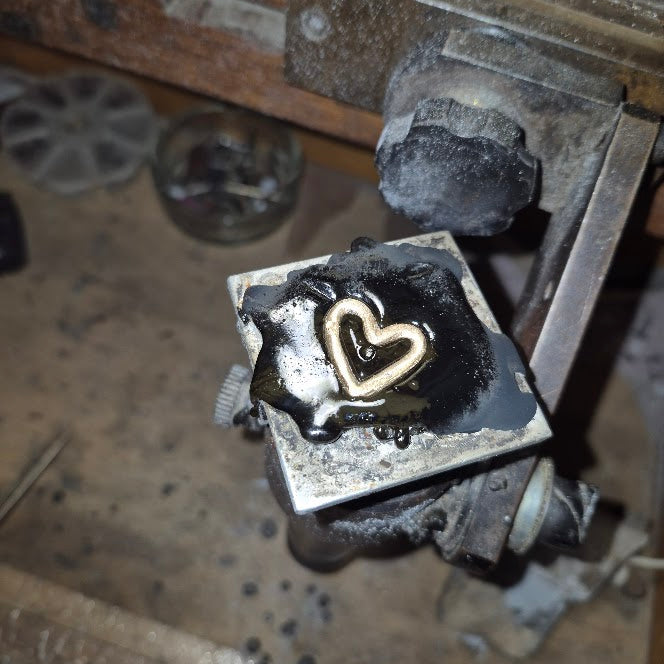 Gold heart charm on a sterling bangle
