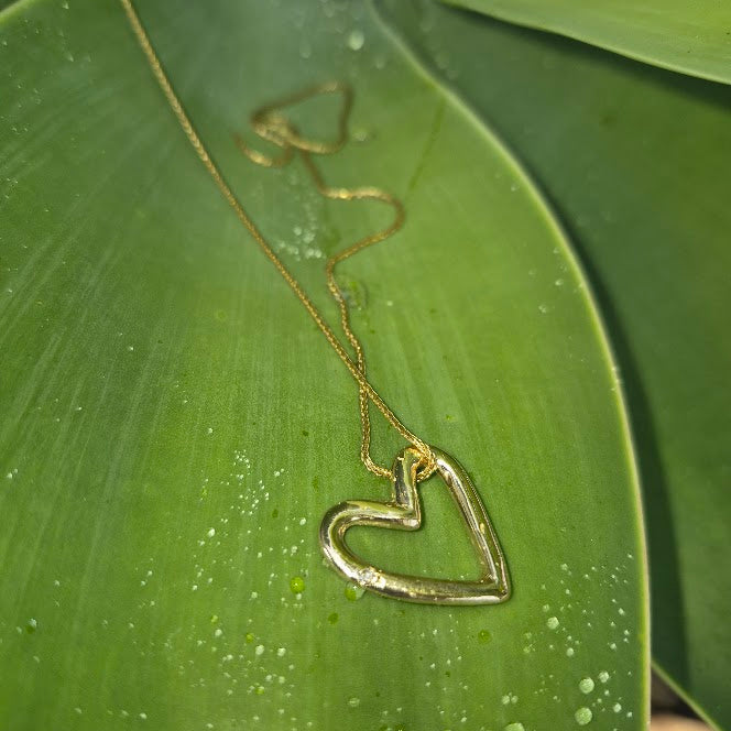 Gold heart charm on a sterling bangle