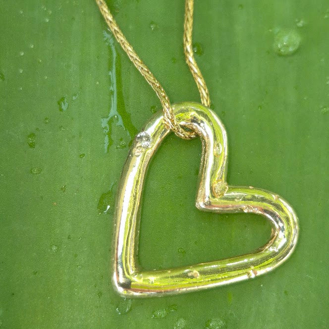 Gold heart charm on a sterling bangle