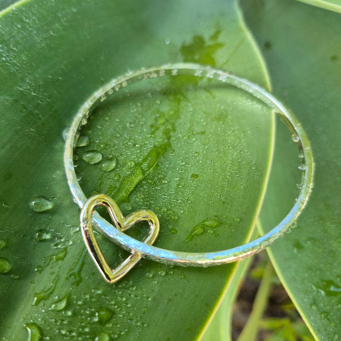 Gold heart charm on a sterling bangle